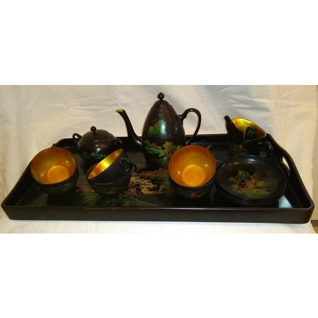 Teapot, sugar bowl, creamer, 6 cups, 5 saucers, 24 x 12.5 inches tray and assorted teaspoons with one sugar cube tong....