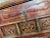 A Chinese lacquered Elm wood side table raised on four rectangular section legs, the body with two long drawers, one with...