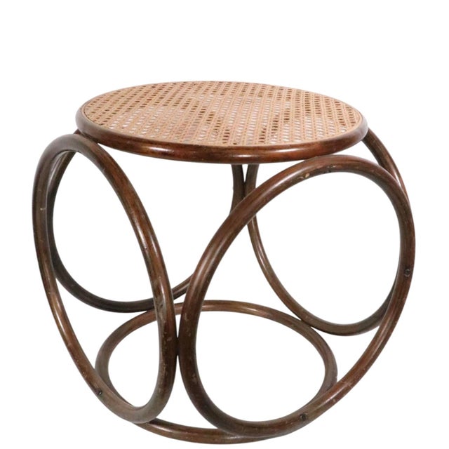 Iconic bentwood and caned Vienna Secessionist style ottoman, stool, design attributed to Michael Thonet. The stool is in...