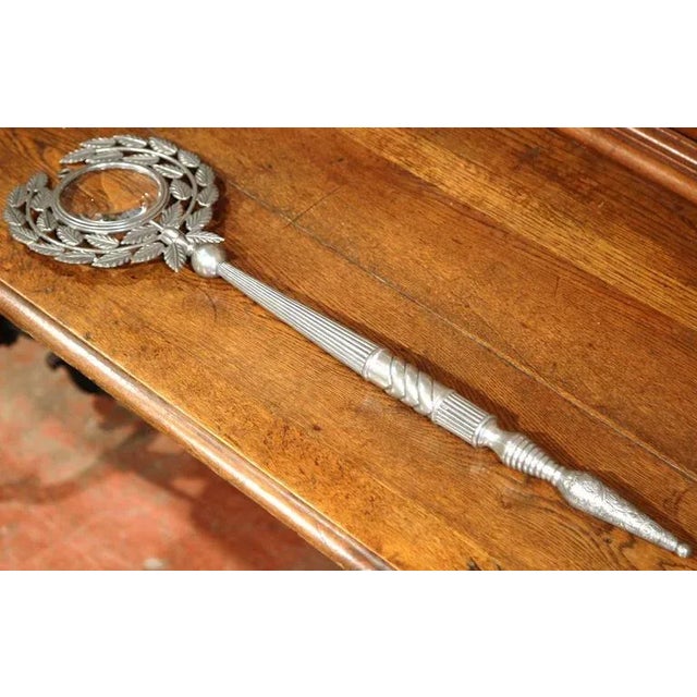 This unusual, antique magnifying glass was crafted in Paris, France, circa 1870. The piece has a pewter frame, a long...