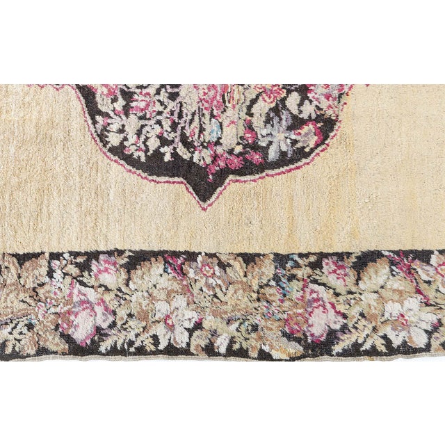 This charming antique Karabagh rug, handwoven in the 1920s, is a stunning example of Caucasian textile artistry influenced...