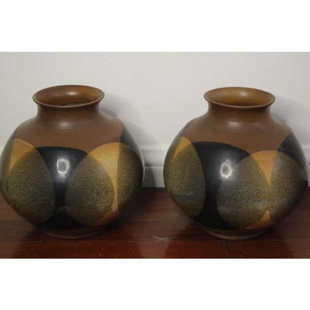 Great looking pair of vintage Pottery Craft vases with a multicolor glaze over the earthen brown body in a design...