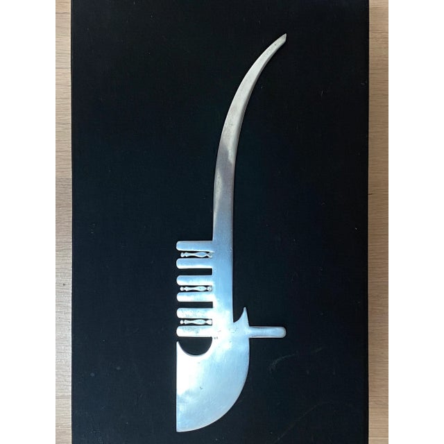 Modernist abstract shaped stainless steel paper opener.