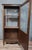 A Louis XV style walnut display cabinet, French work from the mid-20th century. Curved design with a glazed door in the...