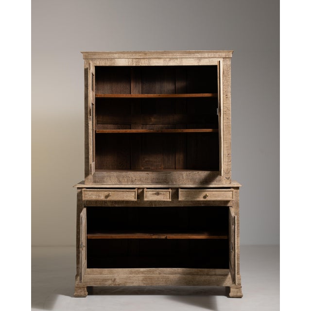 A distinguished example of French provincial craftsmanship from circa 1880, this oak cabinet reflects the restrained...