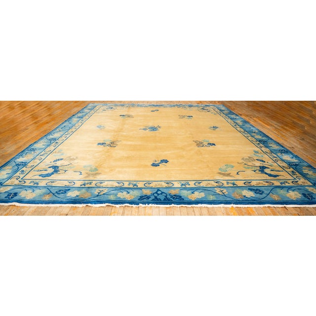A magnificent palace-sized Antique Chinese carpet, circa 1920. Measuring a commanding 12' x 14' 3", this piece features a...