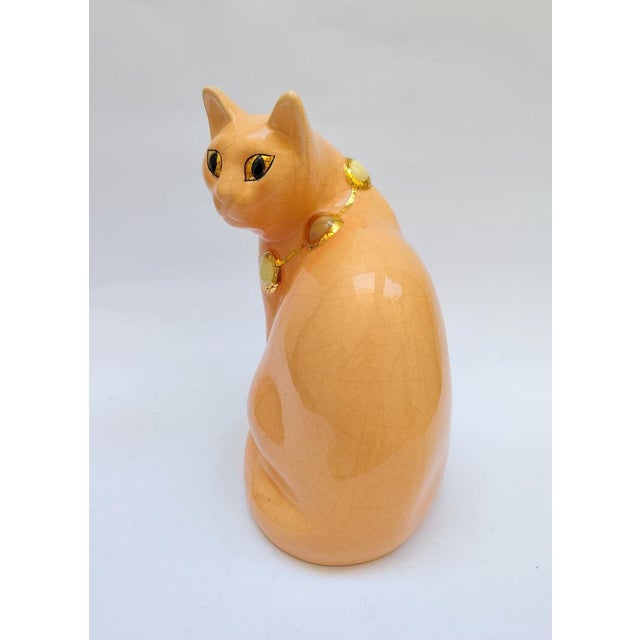 Longwy Salmon pink ceramic cat with cabochon necklace Decorated with gold necklace and eyes Marked under the base Model...