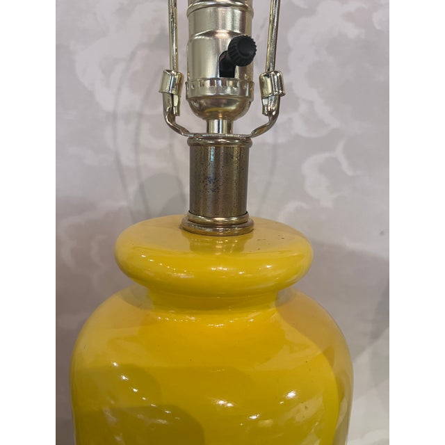 Dramatic pair of vintage yellow table lamps. The lamps have been rewired. They are paired with bold silk Ikat shades...
