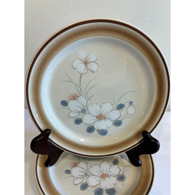 A charming set of four vintage Hearthside Water Colors stoneware salad plates made in Japan. Featuring soft white floral...