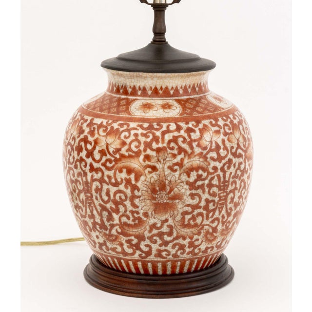 Chinese Iron Red Floral Decorated Porcelain Ginger Jar Mounted as a Lamp, with sphere form porcelain finial and mounted on...