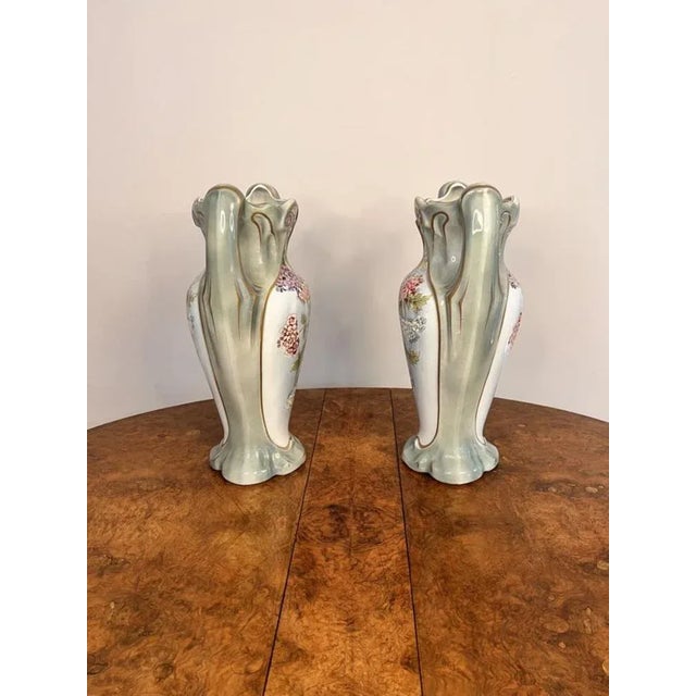 Stunning pair of quality antique French vases with shaped twin handles, a shaped top, having a green ground with gold...