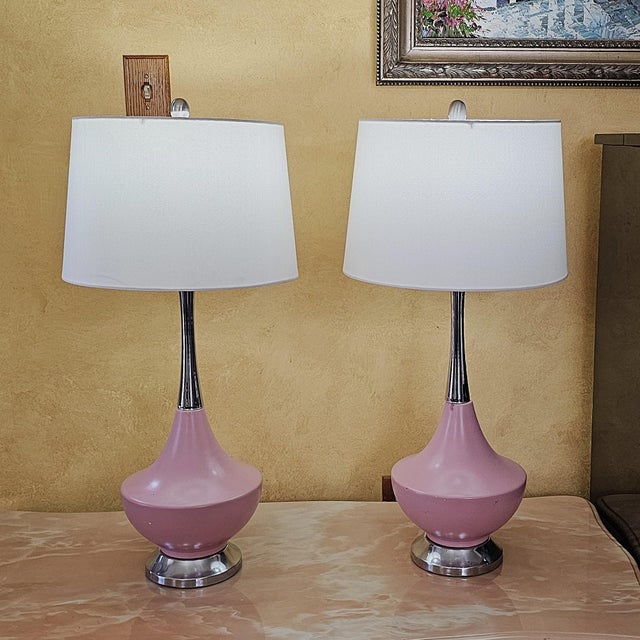 Pair of vintage American-made ceramic table lamps featuring sculptural blush pink bases, chrome-tone necks and bases,...