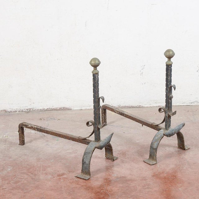 This pair of fireplace andirons makes for an interesting decorative element for the hearth, ideal for lovers of antiques...