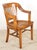 Medium toned wood Arts & Crafts chair with a slated back, high armrests, and box stretchers. There are letters carved on...