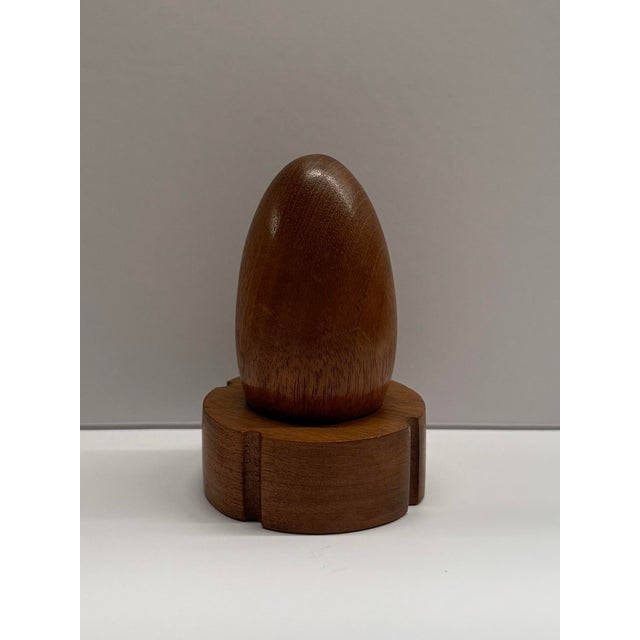 Material: Solid Oak, dark smoked stain finish. Dimensions: Egg - H: 3", D: 1.5". Base - H: 1", D: 2.5". Description: This...