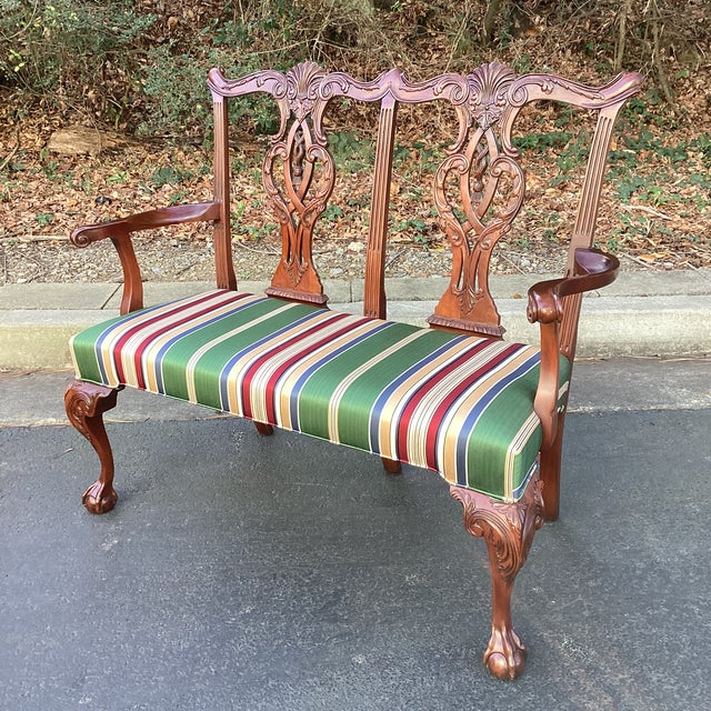 Elegant and finely crafted Hickory Chair settee featuring classic Chippendale-inspired detailing. The sculptural mahogany...