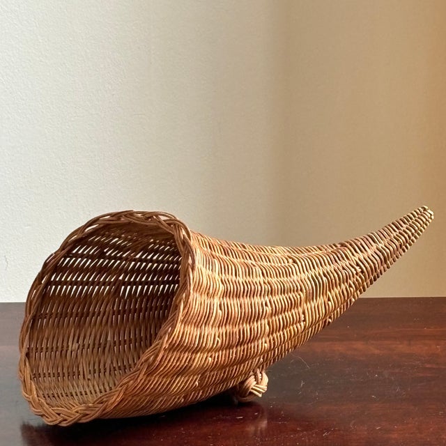 Offering a small, mid-20th century cornucopia basket with footed base. Love the pretty French randing on this basket and...