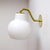 wonderful early pair of wall lights by Vilhelm Lauritzen for Louis Poulsen, with opaline glass shade on brass hardware,...