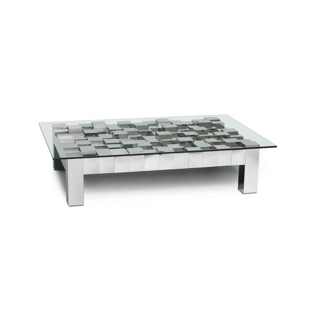 Stacks of stainless steel blocks form the sculptural base of the Flash cocktail table by Oggetti. Its architectural design...