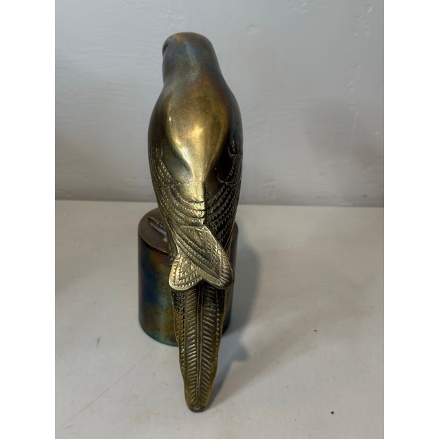 Stunning mid-century modern solid brass parrot sculpture on a heavy pedestal base. This striking vintage statue features...