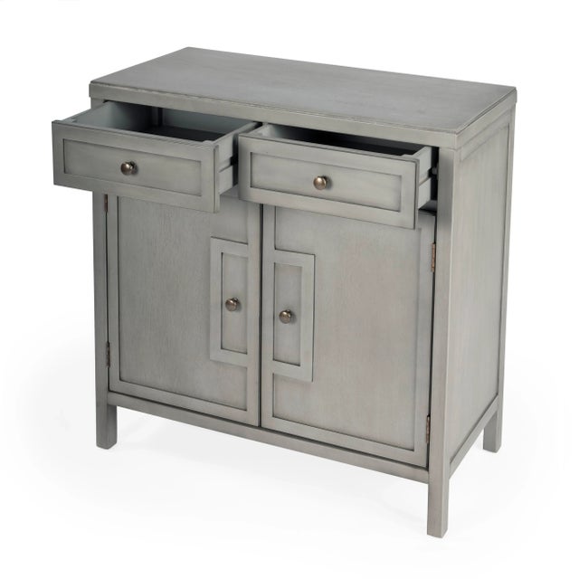 This stylish console cabinet combines Modern minimalism with Eastern design elements. Featuring clean lines and a Gray...