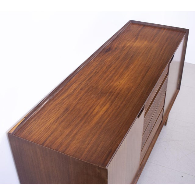 1960s Afromosia sideboard designed by Richard Hornby for Fyne Ladye Furniture Ltd. It has 4 drawers, the top one baize...