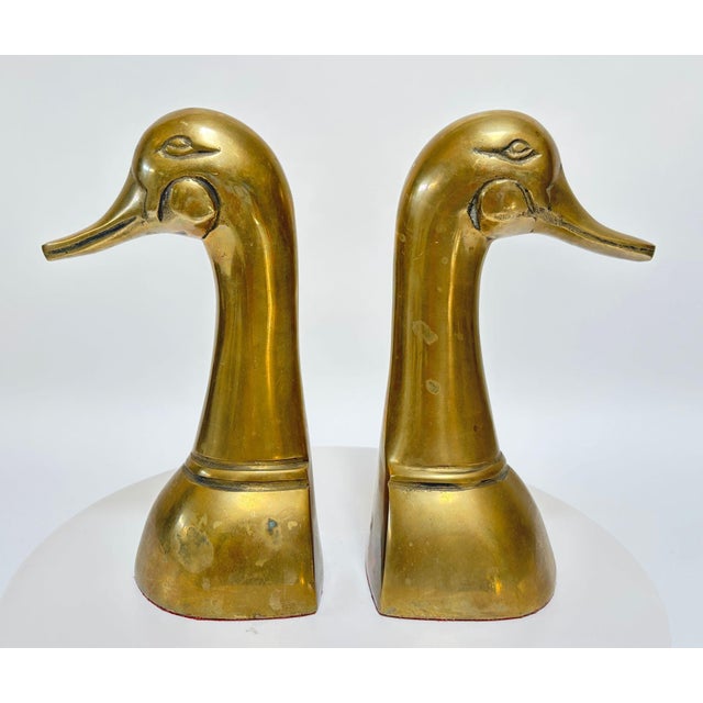 Pair of Large Mid-Century Brass Duck Head Bookends, Sarried Style, circa 1950 A striking pair of vintage Hollywood Regency...