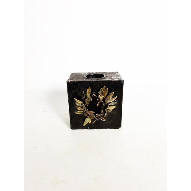 Wax and brass candlestick, France, 1970s, a unique decorative piece blending raw materials and metallic elements. This...