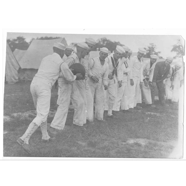 1918 antique photo of US Navy personnel having a medicine ball relay. Publication information on the back.