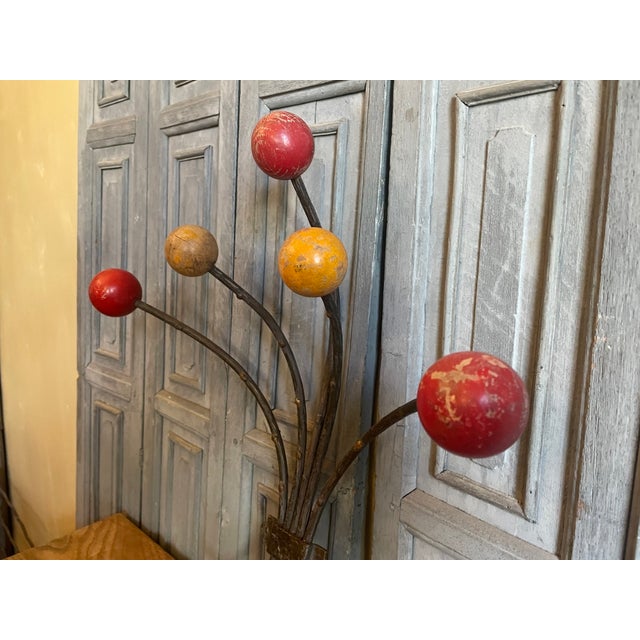 A playful and decorative wall coat rack with ornaments from France. The coat rack actually has iron branches tied together...