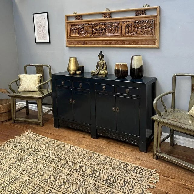 Boasting a regal dark teal lacquer finish, this exquisite antique sideboard hails from China's Shanxi province and dates...