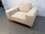 A sophisticated Mid-Century Modern lounge chair featuring a clean, architectural silhouette and generously proportioned...