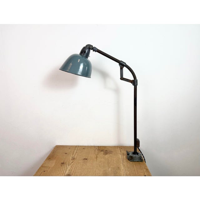 Industrial adjustable table lamp made by Siemens in Germany during the 1950s.It features grey enamel shade with white...