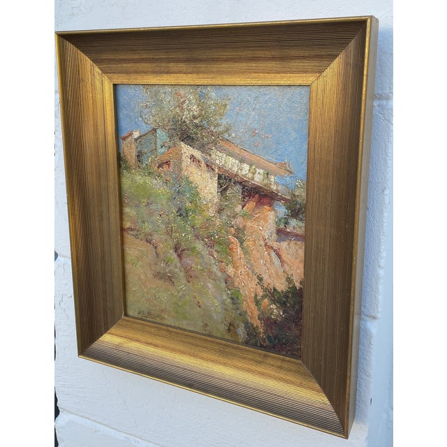 A late 19th century French Impressionist style painting by artist J. S. Dorange depicting a Mediterranean style cliff side...