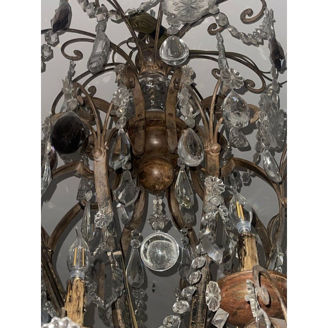 A monumental early 19th-century Venetian chandelier of exceptional scale and presence, executed in wrought iron and wood...