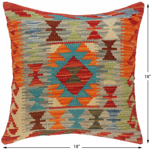 A lattice of small orange and blue diamonds covers a cream ground with teal trim. The all-over pattern adds texture and...