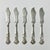 This set of six silverplated butter knives are from the 1930-40s era. They feature an ornate cut shaped blade and grape...