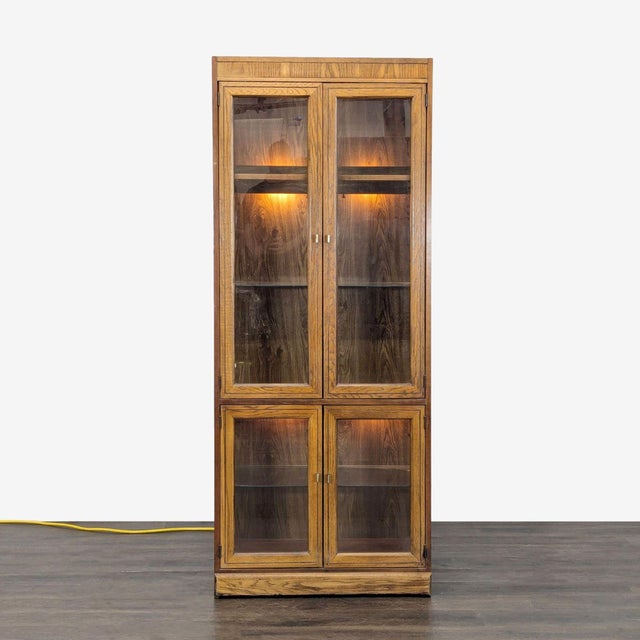 This wood cabinet features interior lighting, glass shelving, and provides plenty of storage space. Dimensions (in): 31W x...