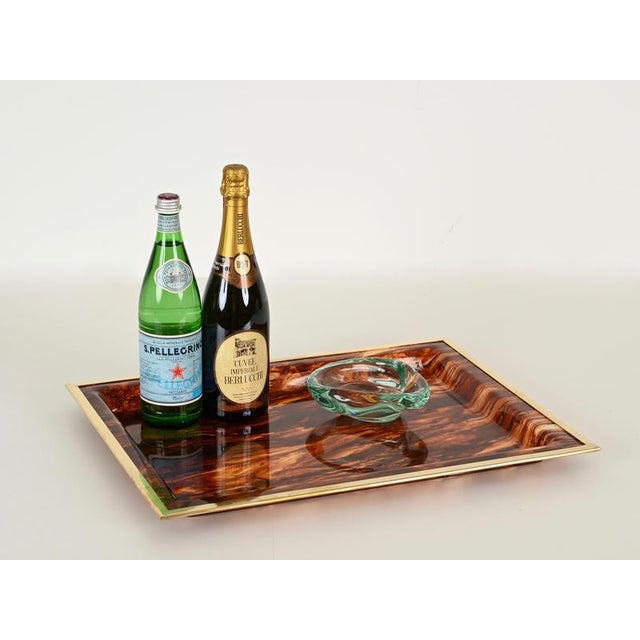 Spectacular midcentury serving tray in an incredibly charming tortoiseshell effect lucite and brass. This incredibly...