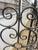 A striking, architectural hand-forged iron screen with elegant scrollwork, substantial weight, and indoor-outdoor...