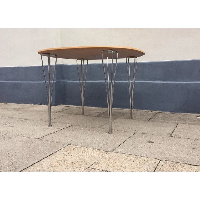 This super-circular dining table was designed by Piet Hein and Bruno Mathsson during the 1960s and manufactured in the...