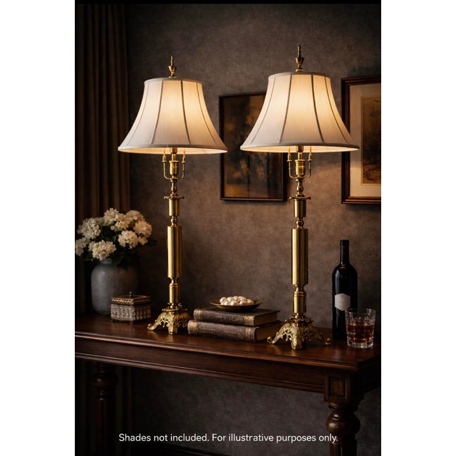 Sculptural pair of vintage brass neoclassical revival table lamps with ornate acanthus-inspired bases and balanced...