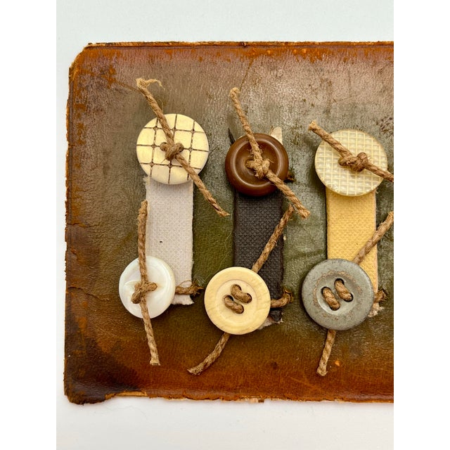 A distinctive vintage modernist assemblage featuring an artful composition of vintage buttons, hand-knotted twine, and...