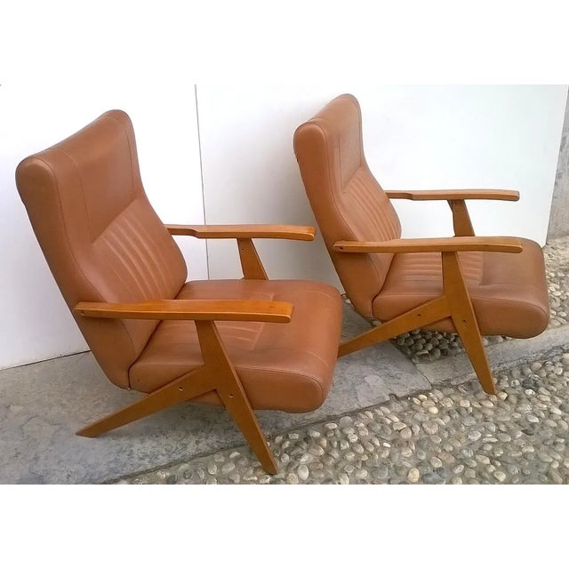 Two reclining armchairs made in Italy. Designer unknown. Original 1960s. Two positions. Beech wood. Brown leatherette....