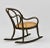 An antique ebonised bentwood low back design rocking chair. Maker's stamp: Thonet. Circa 1900. The chair has the original...