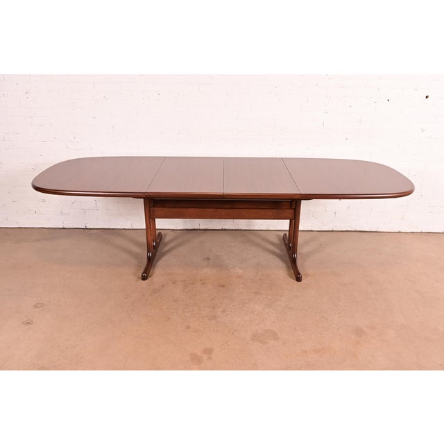 A sleek and stylish mid-century Danish Modern sculpted rosewood extension dining table In the manner of Niels Otto Møller...