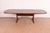 A sleek and stylish mid-century Danish Modern sculpted rosewood extension dining table In the manner of Niels Otto Møller...
