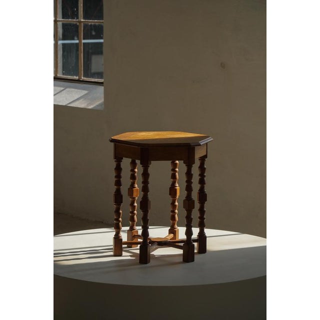 A charming Dansih side table crafted in oak, dating to the 1950s. The table features an hexagonal top supported by...