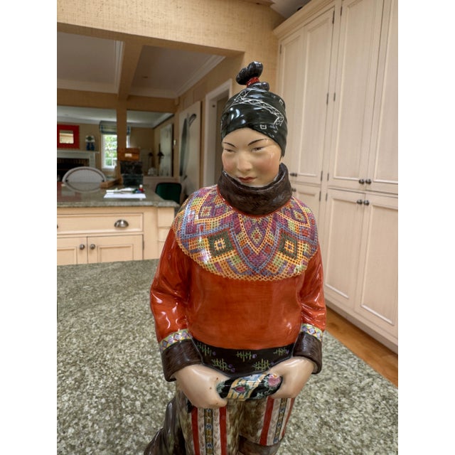This is a beautiful pair of Royal Copenhagen figurines by Carl Martin-Hansen of a man and a woman in traditional Greenland...