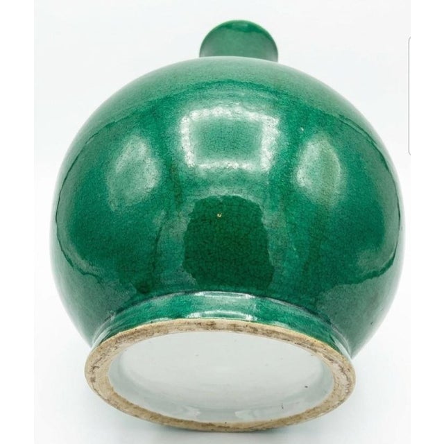 Apple-green crackle-glazed porcelain bottle vase, Qing Dynasty, 18th Century with two rings, long slender cylindrical...
